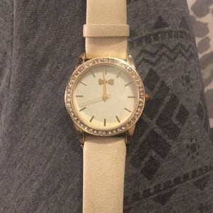 A stainless steel watch outlined with diamonds